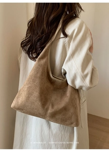 Vue arrière du sac cabas en daim marron porté avec un trench pour un style rétro
