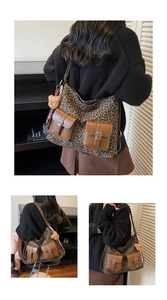 Detail view of retro leopard print tote bag featuring brown leather pockets and bear charm