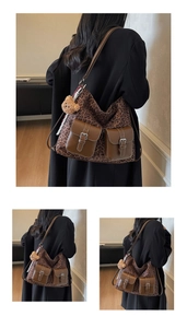 Detail of leopard print tote bag with brown leather front pockets and plush bear charm