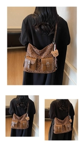 Detailed back view of vintage leopard print tote bag with brown flap pockets and teddy charm