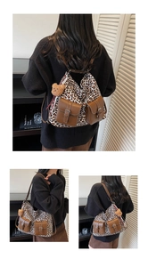 Detailed view of leopard print backpack with brown pockets and plush bear charm