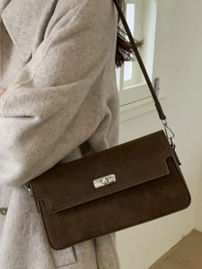 Brown frosted suede underarm bag with silver twist lock shown on model for office commute