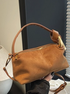 Brown faux suede cylinder handbag with gold metal ring and top handle strap