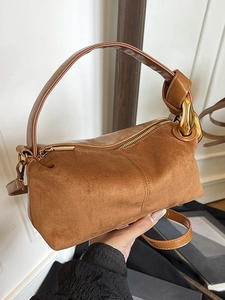 Brown frosted suede cylinder handbag with gold metal ring and adjustable shoulder strap