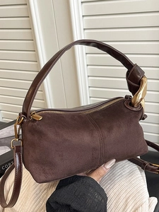 Dark brown suede cylindrical handbag with gold chain handle and shoulder strap