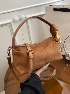 Brown suede cylinder handbag with knotted handle and thick gold chain strap for women
