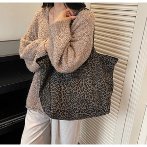 Close-up of vintage leopard print tote bag showing fabric texture and shoulder strap