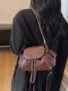 Brown quilted oil wax leather backpack with metal chain strap for women commuters