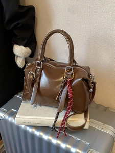 Vintage brown glossy PU Boston bag with woven pendant and adjustable strap for women