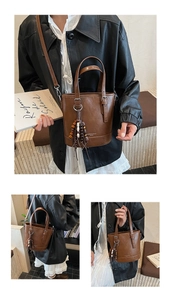 Close-up of brown leather bucket bag with decorative wooden bead tassels and crossbody strap