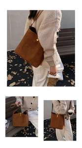 Detail of a brown suede tote bag featuring a gold square buckle and structured shoulder strap