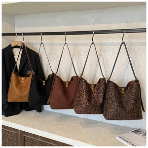 Detailed display of five colors including leopard print suede tote bags with gold clasp