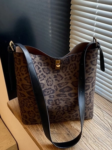 Chic leopard print tote bag with black leather straps and gold twist lock closure