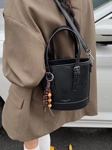 Minimalist black bucket bag with wooden beads and adjustable shoulder strap for women