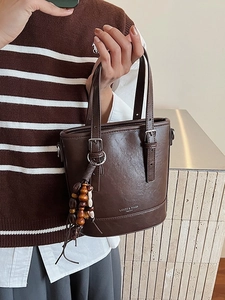 Minimalist deep brown bucket bag with vintage wooden beads and adjustable shoulder strap