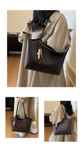 Detail of vintage brown tote bag featuring unique colorful beaded charm and smooth PU leather