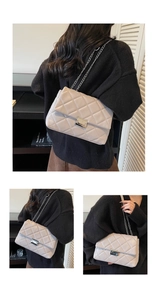 Detail of quilted diamond pattern and silver metal twist lock on the beige small square bag