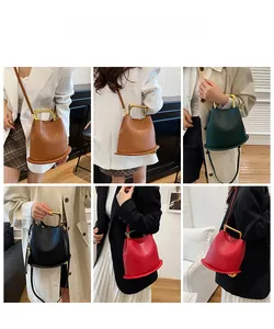 Chic bucket bag with gold U-shaped metal handles in four elegant colors and crossbody strap