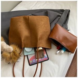 Detail view of brown suede-like woven tote bag set showing spacious interior storage