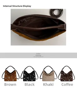 Detail view of suede shoulder bag with metal eyelets and internal zipper pocket