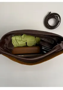 Interior view showing large capacity of the brown patchwork tote bag with essentials