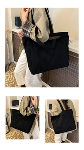 Macro detail of large black suede tote bag showing durable fabric and soft texture