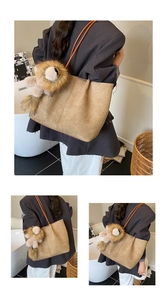 Detail of khaki woven tote bag with brown straps and cute lion plush charm