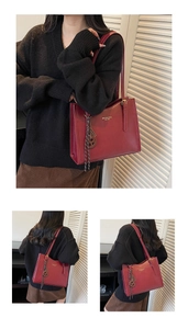 Detail of vintage burgundy tote bag with gold lettering shown on model for autumn style