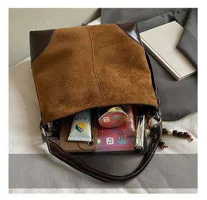 Detail of suede tote bag interior showing large capacity for tablet and cosmetics