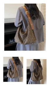 Leopard print hobo tote bag with brown leather strap and gold eyelets on a shoulder