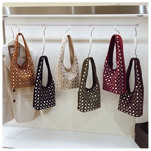 Group display of rivet studded suede shoulder bags in six various vintage colors