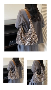 Detail shot of leopard print hobo bag showing fabric texture and brown leather strap