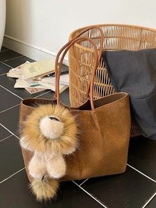 Caramel brown woven suede tote bag with plush lion charm and large capacity for women