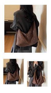 Detail of leopard print tote bag with brown leather strap and spacious interior