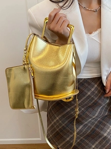 Metallic gold bucket bag with rigid metal handle and matching small pouch set