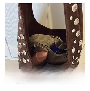 Detail view of the brown suede bucket bag interior showing capacity for makeup and phone