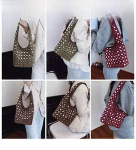 Gothic style rivet tote bags in army green, burgundy, and brown worn by model