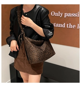 Detail of leopard print pleated shoulder bag showing the large capacity and canvas texture