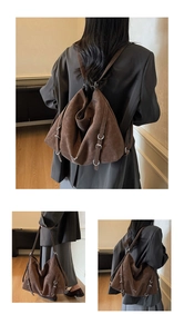 Detail of brown faux suede tote showing adjustable silver buckles and shoulder strap use