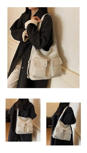 Detail view of beige canvas tote bag with front flap pockets and metal button accents
