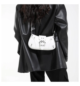 Chic white retro saddle bag featuring silver metal buckle and rivets on black leather jacket