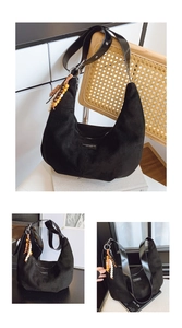 Detail of black faux suede hobo bag with colorful wooden beads and a sleek leather strap
