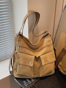 Large mustard yellow canvas tote bag with front flap pockets and wide shoulder strap