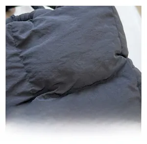 Close-up of black quilted nylon fabric showing detailed stitching and padded texture