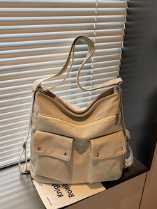 Minimalist beige canvas tote bag with large capacity and adjustable shoulder strap