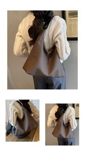 Detail view of large brown hobo bag showing matte synthetic leather and wide strap design