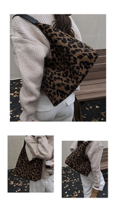 Detail of leopard print tote bag showing fabric texture and black leather shoulder strap