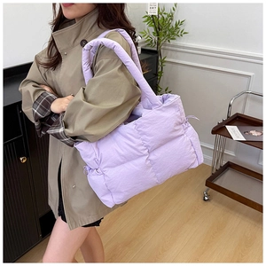 Detail of lavender quilted puffer tote bag with thick soft handles and drawstring side