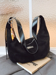Large black suede hobo bag with leather strap and decorative colorful wood beads