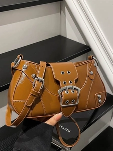 Vintage caramel brown saddle handbag with contrast stitching and metallic eyelets